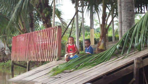 Two toddlers on their front porch.